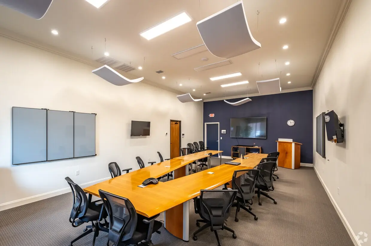 Peden Yards boardroom with conference table and media wall